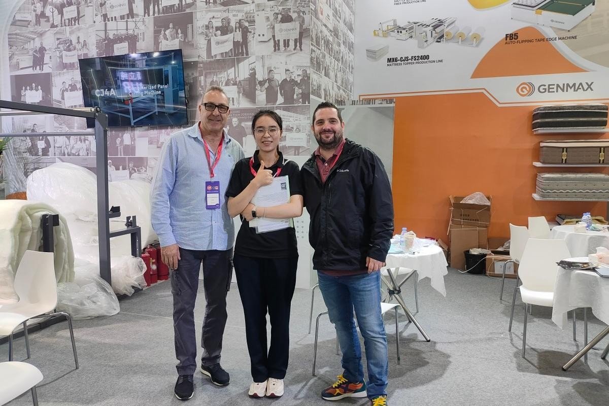 GENMAX team and customers posing for a group photo in front of the company’s CIFF Guangzhou exhibition booth.