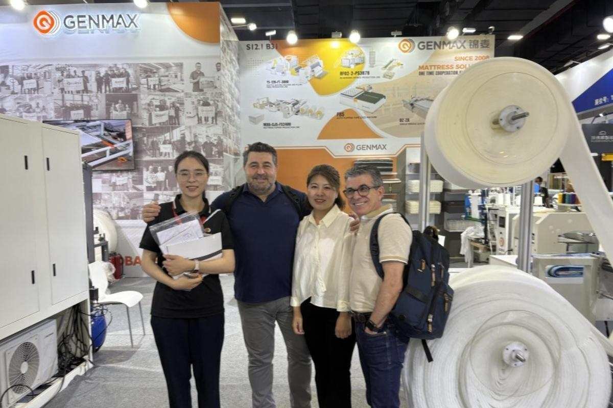 GENMAX technical team explaining machine features to a visiting customer at the CIFF exhibition.