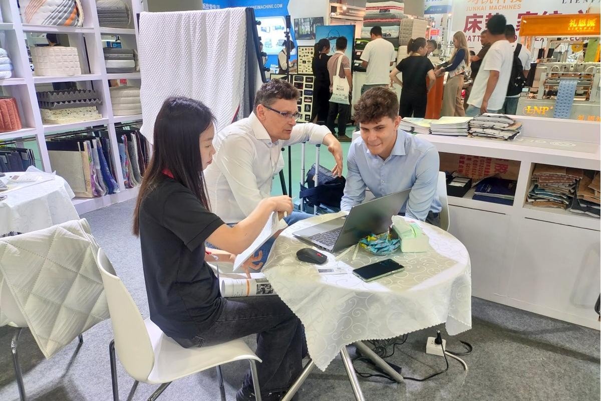 GENMAX sales representatives and customers engaged in a business negotiation at the CIFF Guangzhou exhibition booth.