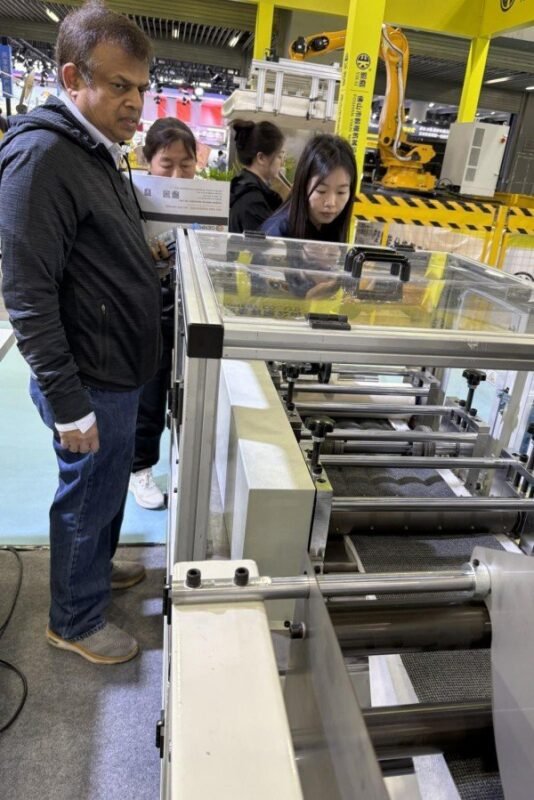 GENMAX specialist demonstrating live machine operation for a customer during the CIFF exhibition.