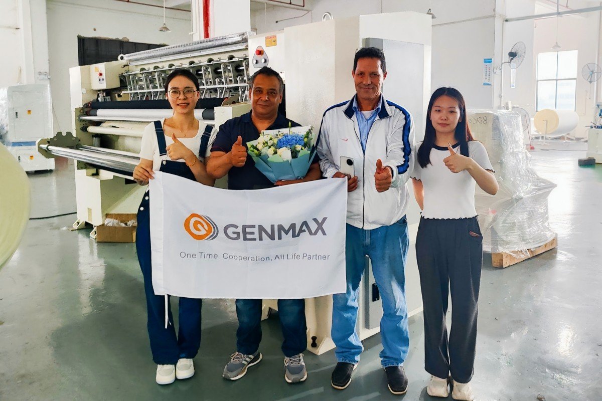 Genmax professional sales team demonstrating advanced quilting technology features to Moroccan customers at the manufacturing facility.