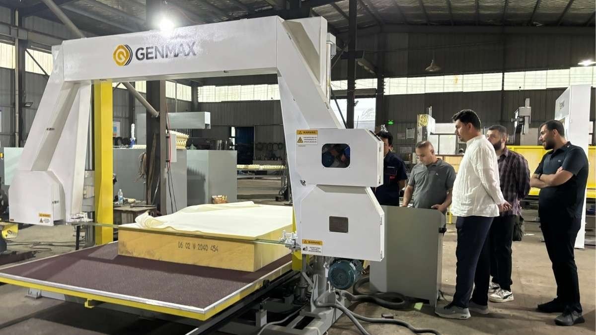Iraqi customers observing the industrial sponge straight cutting machine series in action during their comprehensive factory tour of foam processing equipment.