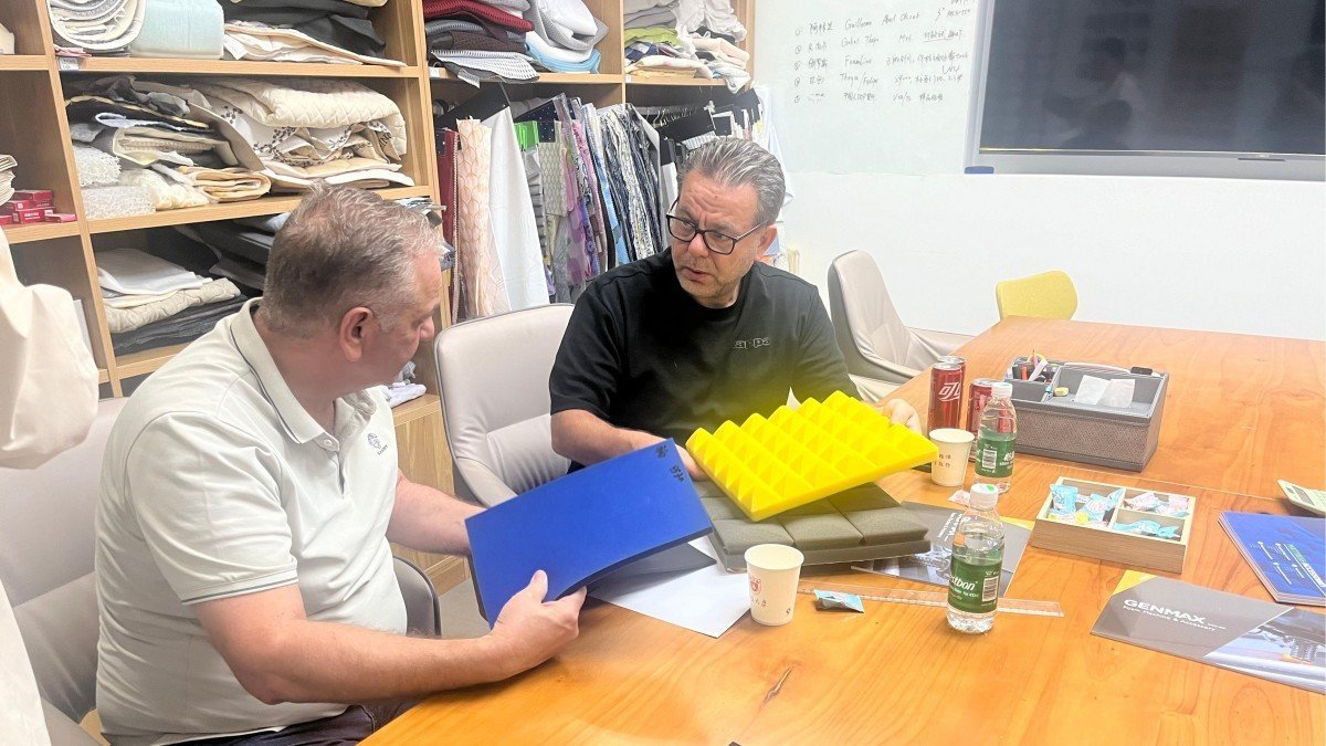 Jordanian customers engaged in detailed discussion about mattress product specifications with technical experts in the company's conference room while evaluating material samples.