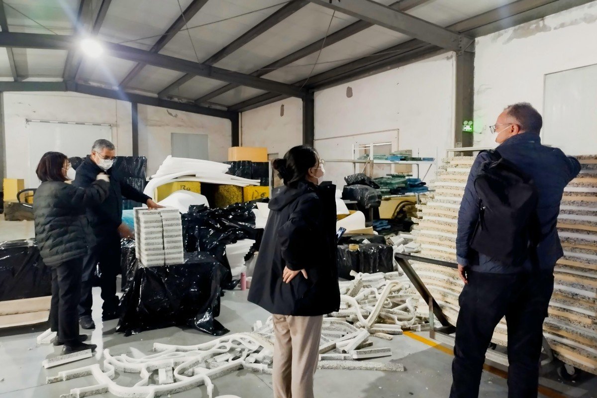Moroccan industrial buyers carefully inspecting the quality of finished recycled foam products produced by the rebonding machine system during their factory assessment visit.