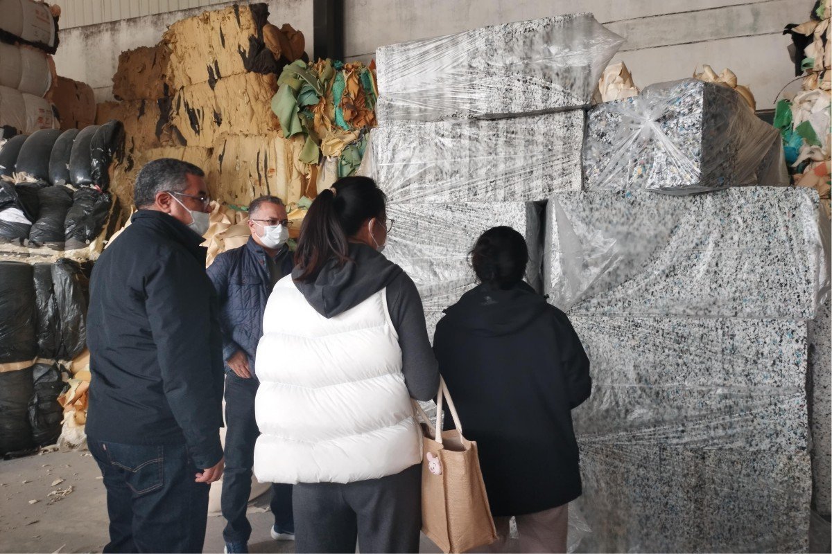 Moroccan delegation conducting hands-on quality assessment of recycled foam products manufactured through the rebonding process at the production facility.