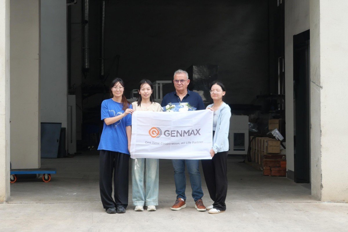Puebla customers from Mexico posing for a commemorative group photograph with factory staff at the main entrance after touring the quilting machine manufacturing facility.