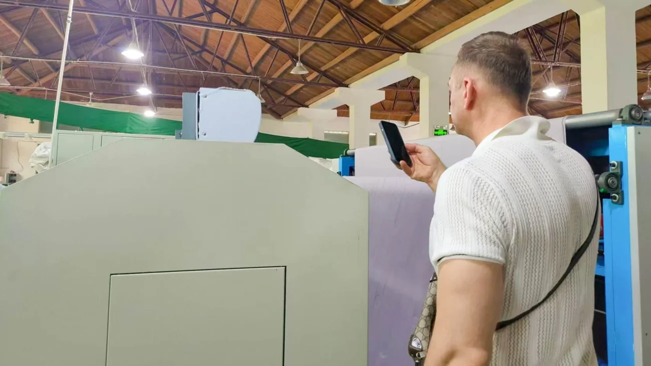 Customers watching the textile machine in operation to evaluate performance