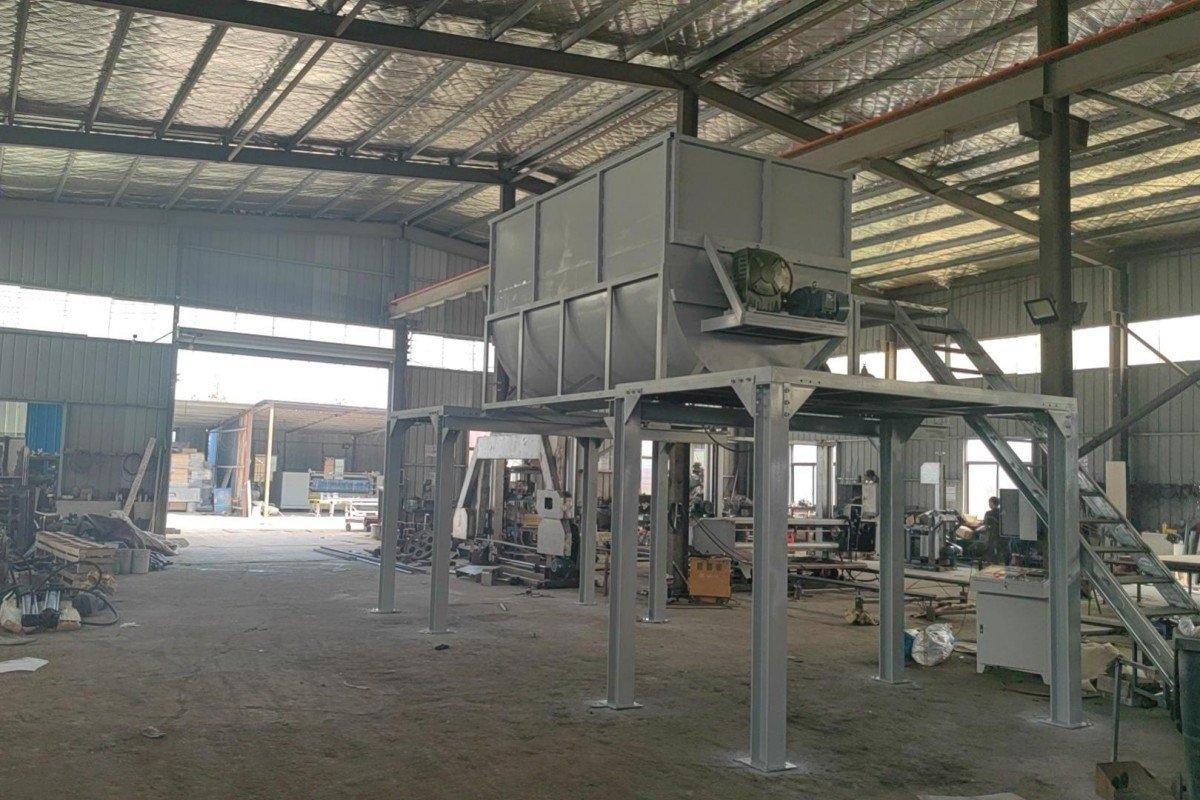 Panoramic view of a complete recycled sponge production line showing the integrated hydraulic press system and foam processing equipment from a manufacturing distance.
