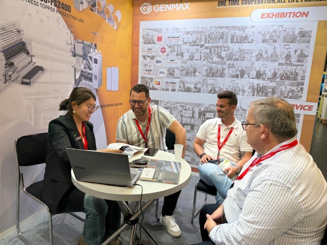 Production managers examining GENMAX's innovative solutions for processing eco-friendly fabrics during an interactive demonstration at Interzum 2025.