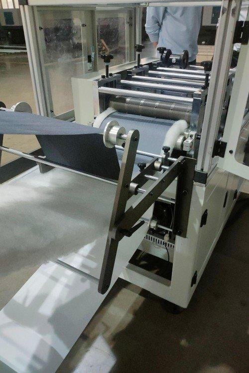 Display of finished product samples produced by the small ultrasonic quilting machines showing various pattern capabilities and material applications for home textiles and automotive interiors.