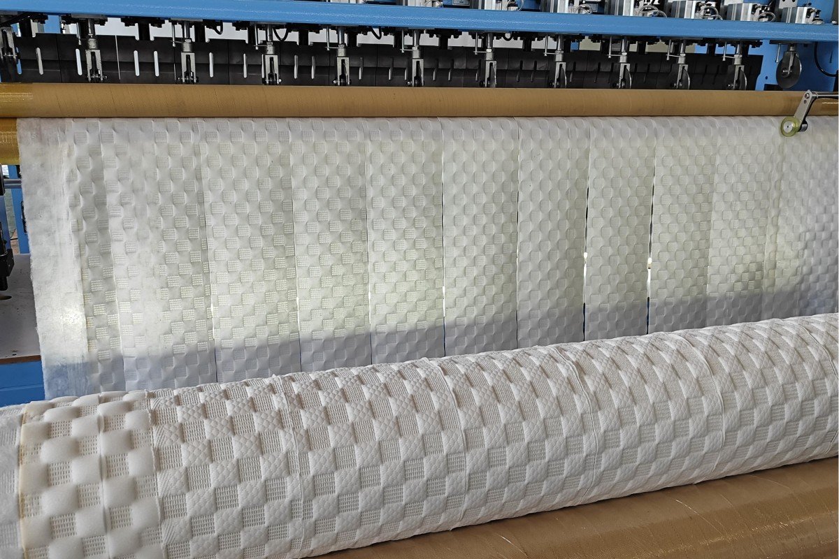 Sample of finished ultrasonic quilted fabric showcasing the seamless bonding, decorative patterns and superior quality achieved through needle-free ultrasonic technology for mattress and home textile applications.