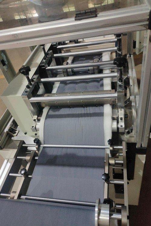 Close-up view of the ultrasonic quilting technology bonding multiple fabric layers without needle and thread during a live demonstration of the production capabilities.